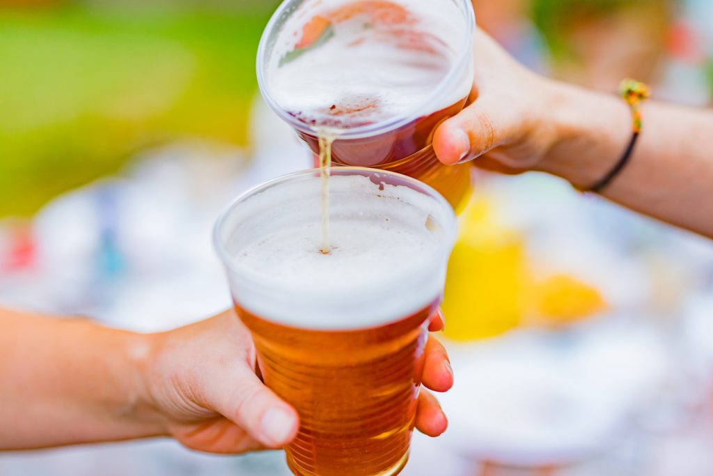 Dues mans sostenint gots de cervesa plens